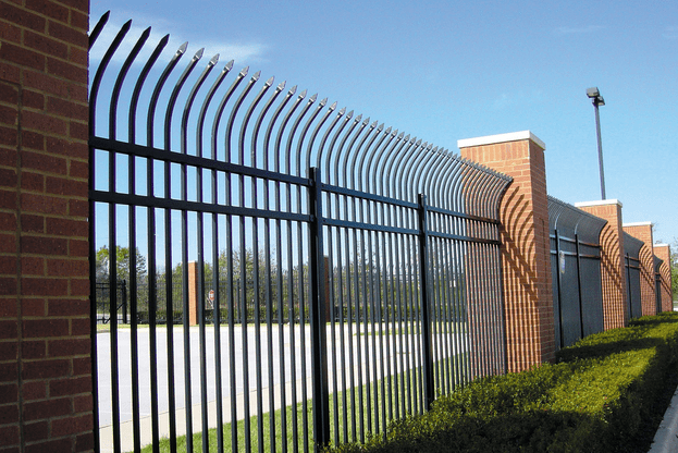 Fence types. Commercial fencing. Black metal fence with brick columns
