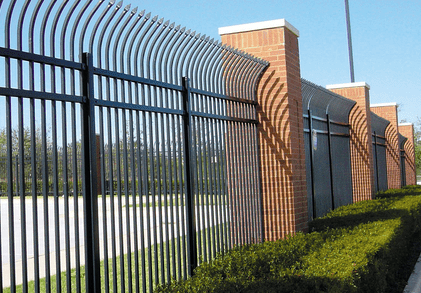 Fence types. Commercial fencing. Black metal fence with brick columns