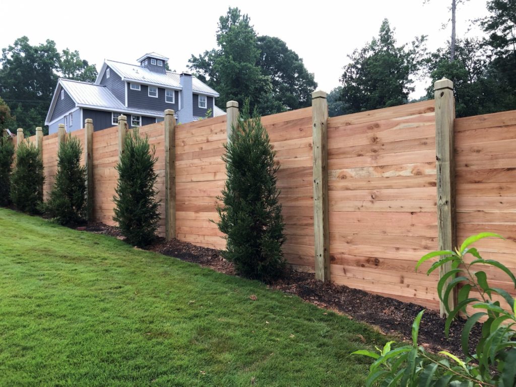 Atlanta fence company Wood residential privacy fence with bushes
