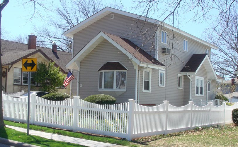 pvc saddle picket fence in front of a house